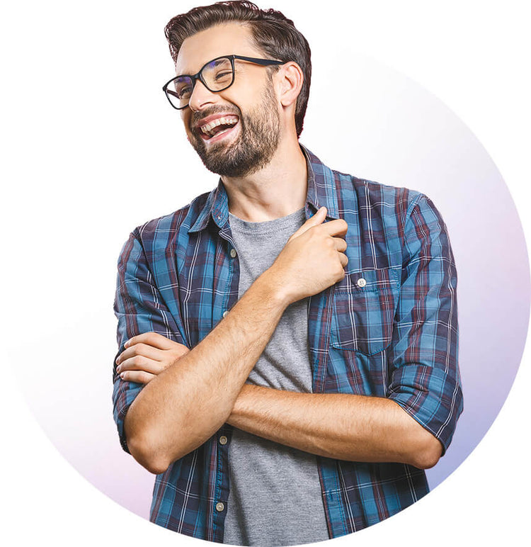 Young man with glasses and a beard laughing